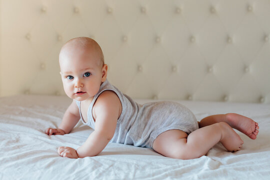 Male baby tummy time on the bed.