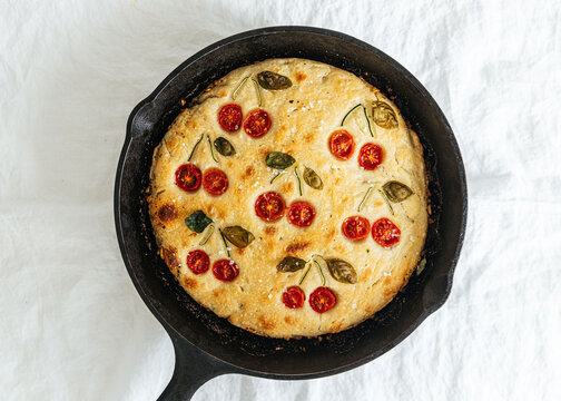 Baked cherry tomato bread in cast iron pan