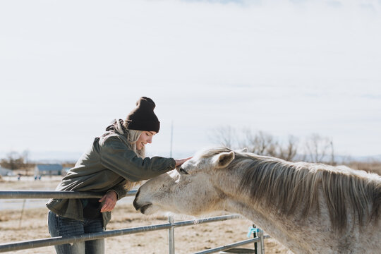 Woman Pets Horse on Head
