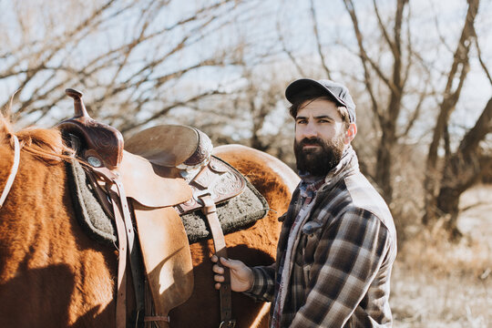 Handsome Rancher Standing with Horse