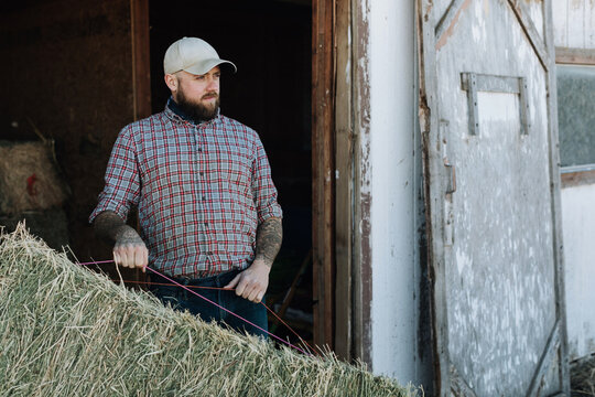 Farmer Holds Bale of Hay