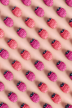 top down view of some raspberries on pink background