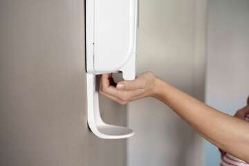 Woman using disinfectant gel in a hand