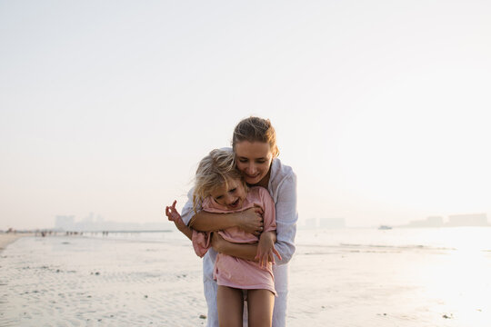 Happy mother and daughter on the beach
