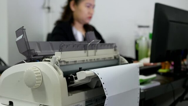 closeup of continuous paper printer in the office.