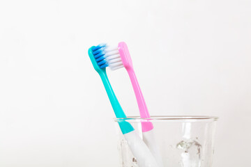 Two couple toothbrushes in the cup