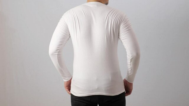 Blank long sleeved shirt mock up template, back rear view, Asian man wear plain white t-shirt isolated on white. Tee design mockup presentation