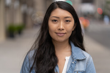 Young Asian woman in city smile happy face portrait