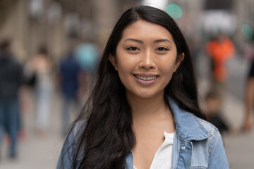 Young Asian woman in city smile happy face portrait