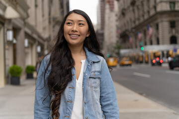 Young Asian woman in city walking street smile happy face