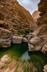 Fototapeta na wymiar wadi shabs in the sultanate of oman. rocky gorge along the path way to a water spring