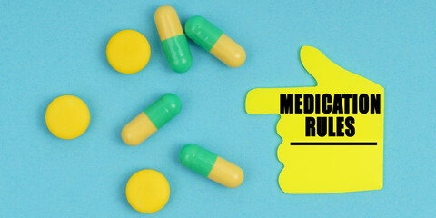 On a blue background, there are pills and a hand-sticker with the inscription - Medication rules