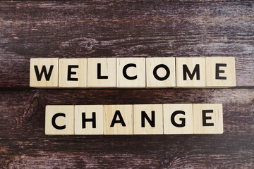 Welcome Change word alphabet letters on wooden background