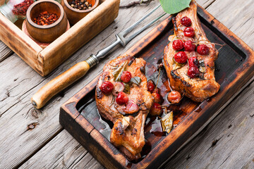 Grilled pork steaks with cherry sauce