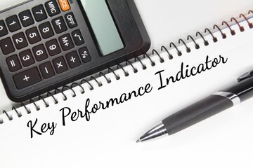 calculator, pen, white paper and Key Performance indicator words