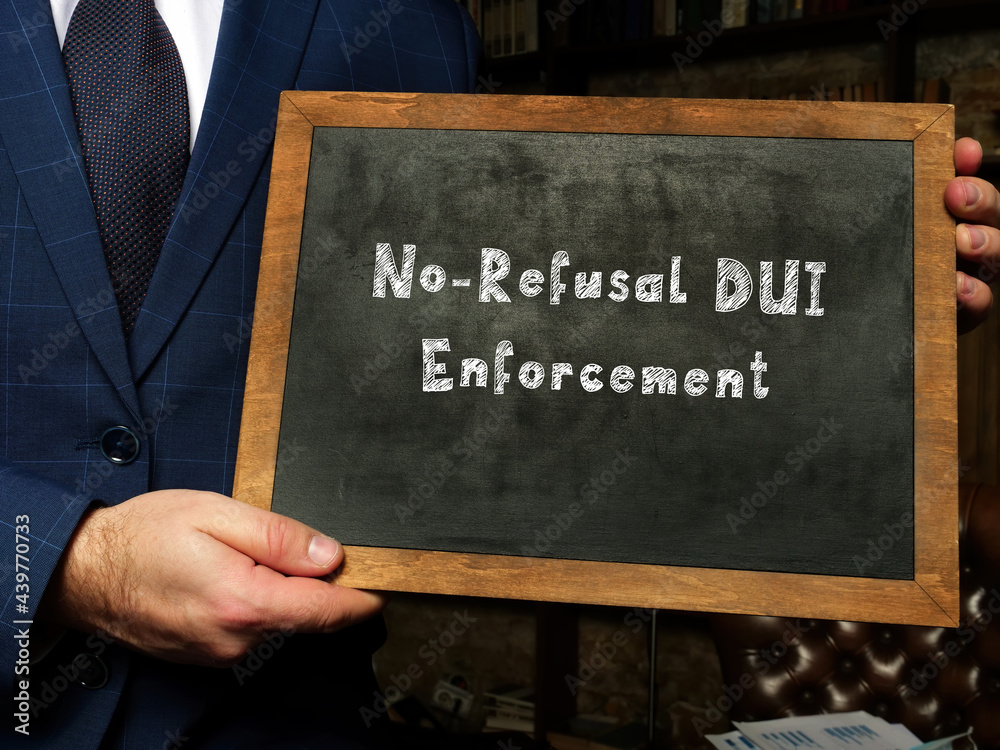 Wall mural Young man holding a card in hands. Conceptual photo about No-Refusal DUI Enforcement with written text.