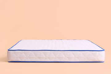 Modern orthopedic mattress on color background