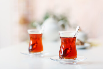 Glass with hot Turkish tea on table in kitchen