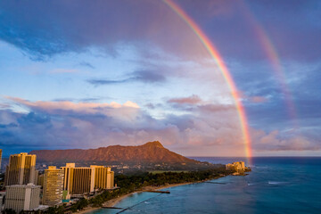 Hawaii's Diamond Head at sunset with a double rainbow above it