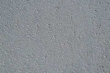 Dark gray asphalt textured background, top view. Rough road surface backdrop