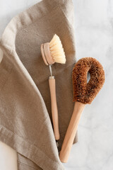 Zero waste kitchen cleaning concept. Eco friendly natural cleaning tools and products, bamboo dish brushes. No plastic, eco-friendly lifestyle. Top view, flat lay.