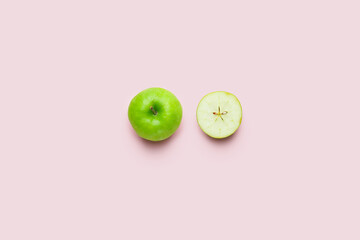 Fresh green apple with piece on color background
