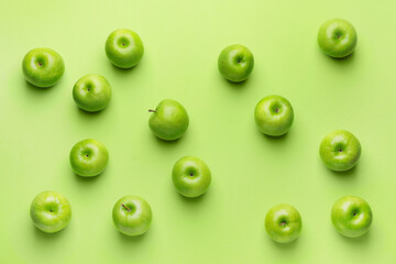 Fresh green apples on color background