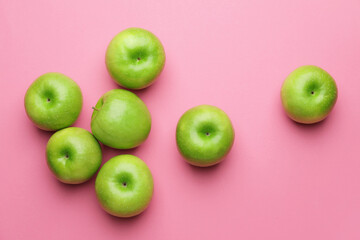 Fresh green apples on color background
