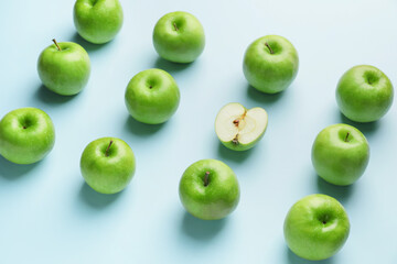 Fresh green apples with piece on color background