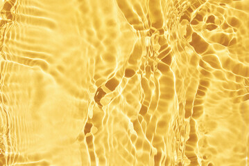 Yellow water surface background. Water texture with reflections, splashes and bubbles. Summer nature background