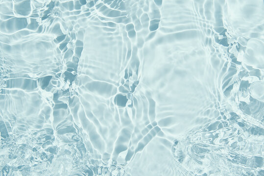 Blue water surface background. Water texture with splashes and bubbles. Summer nature background