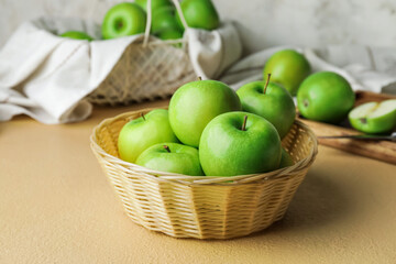 Basket with fresh green apples on table