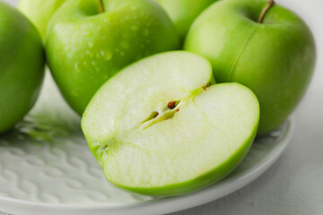 Plate with fresh green apples on white background, closeup
