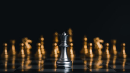 The silver king chess stood in front of the golden chess. Demonstrates leadership in strategic thinking and business victories.on black background.
