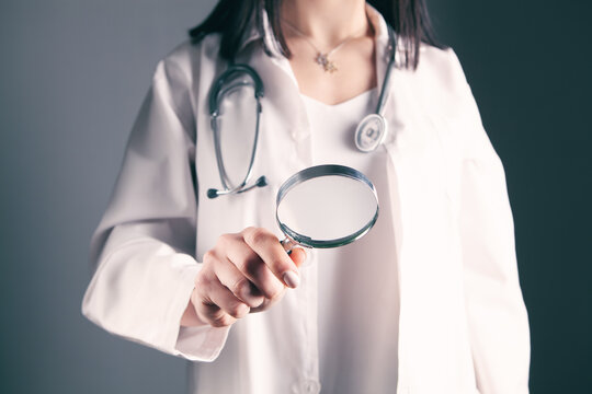 Doctor Holding A Magnifying Glass