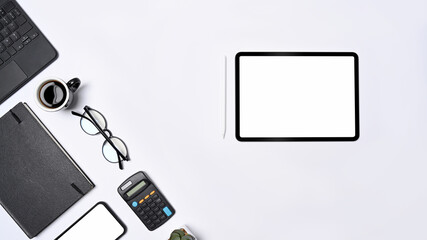 Top view digital tablet, smart phone, calculator and glasses on white background.