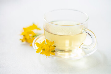 Obraz na płótnie Canvas Herbal tea st. john's wort in glass cup. Alternative Medicine and Relax Drink