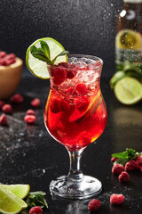 Spritz cocktail with apple cider, campari, raspberries, lime, mint