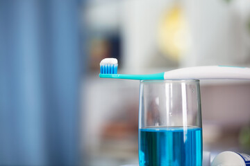 Squeezed toothpaste and toothbrush in the mouthwash