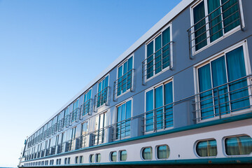 Side view of a river passenger ship against the sky, bottom view. River cruise liner