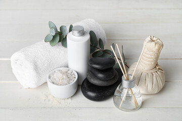 Set of spa supplies on white wooden background