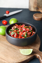 Bowl of tasty Pico de Gallo salsa on table