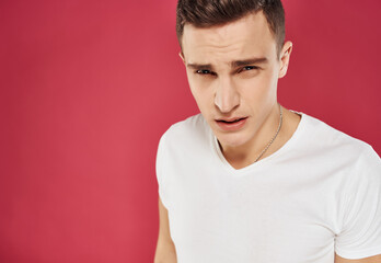 man in white t-shirt cropped view red background studio emotion