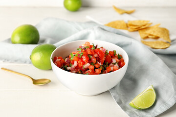 Bowl of tasty Pico de Gallo salsa on table