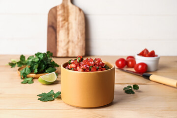 Bowl of tasty Pico de Gallo salsa on table