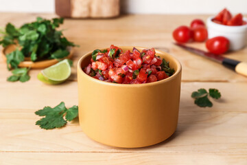 Bowl of tasty Pico de Gallo salsa on table