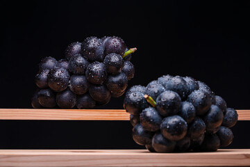 Large Grapes On A Board On A Black Background.
A variety called Nagano Purple