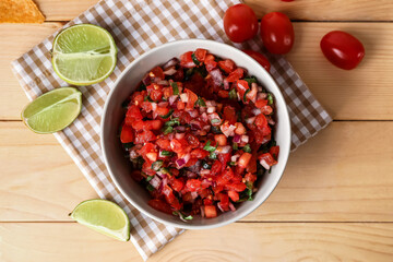 Bowl of tasty Pico de Gallo salsa on table