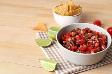 Bowl of tasty Pico de Gallo salsa on table
