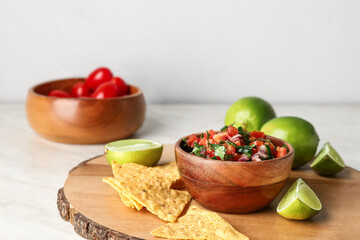 Bowl of tasty Pico de Gallo salsa and nachos on table